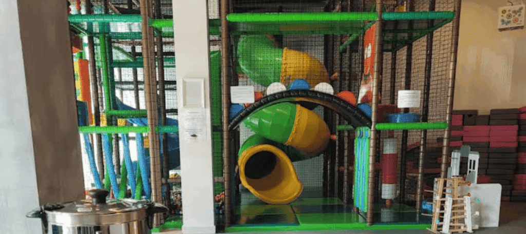 Indoor playground with colorful slides and soft play structures designed for children’s fun and safety.