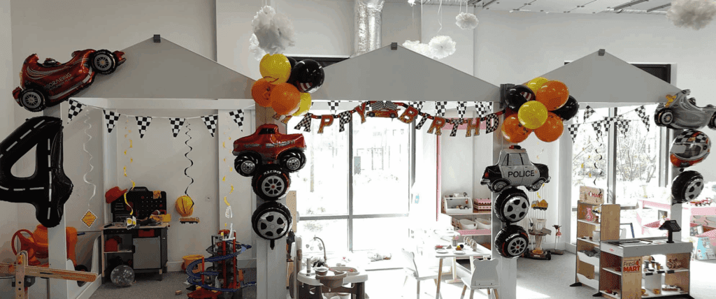 Race car–themed birthday party setup with balloons, banners, and playful decorations.